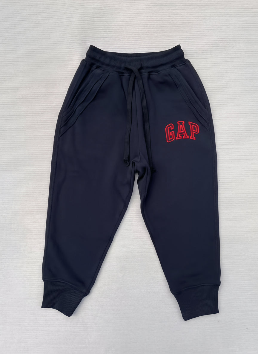 Navy blue sweatpants with 'GAP' logo on a light gray background