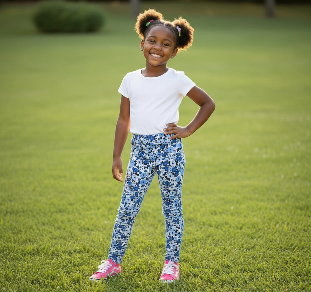 Floral patterned pants on a fluffy surface with a small toy and color chart.