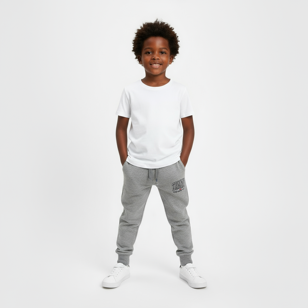 Four pairs of Tommy Hilfiger sweatpants in gray, navy, black, and red on a beige surface.